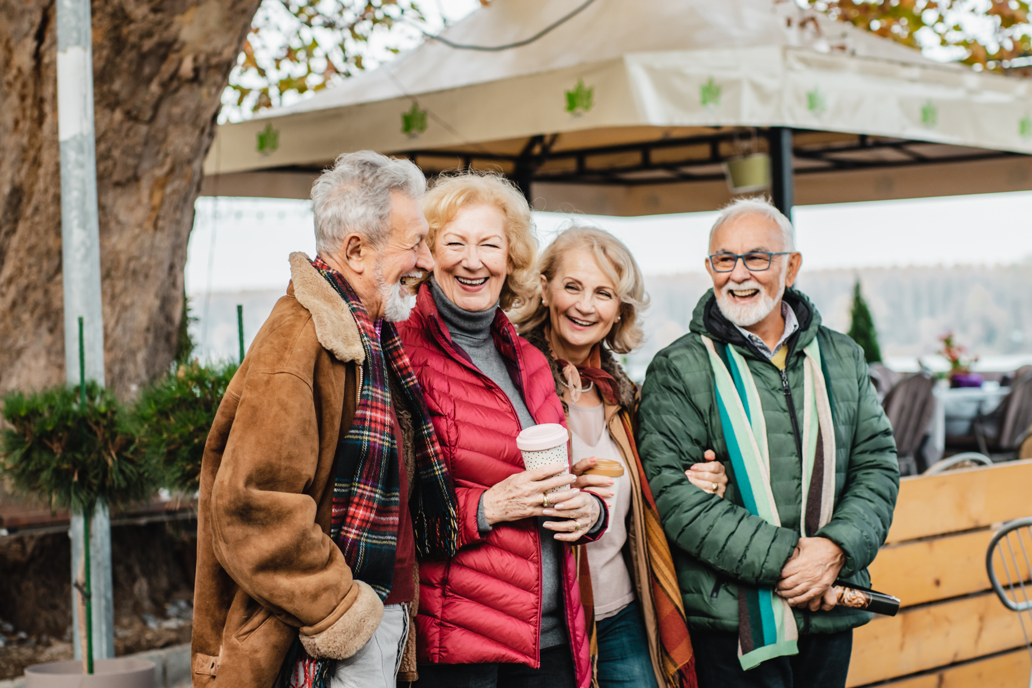 Two senior couple walking and laughing in the city